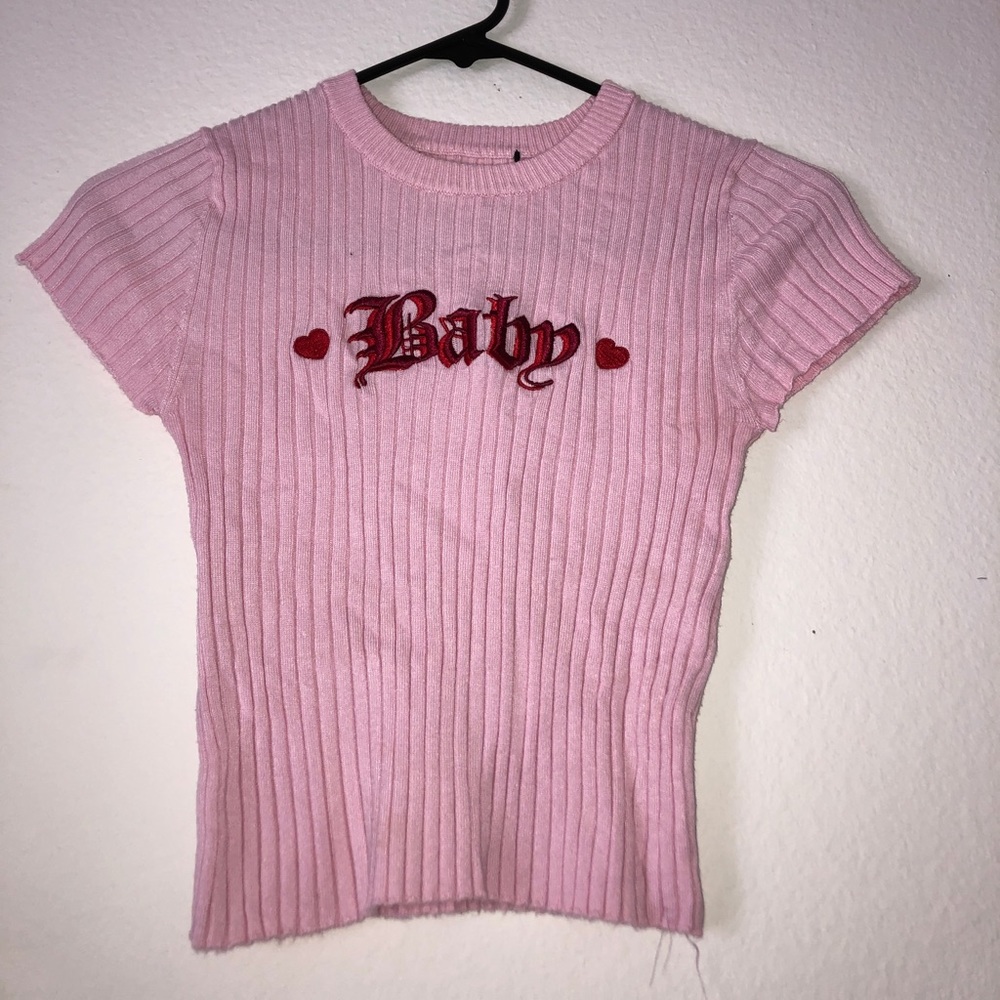 light pink textured crop top that says baby